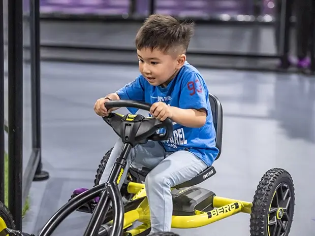 A kid plays on the Pedal Car Track at SuperPark Melbourne