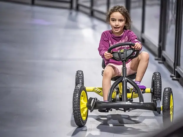A young girl enjoys the thrills of the Pedal Car Track at SuperPark