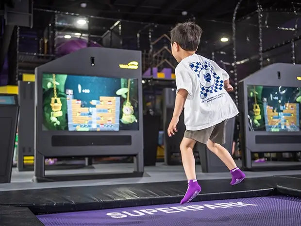 Young boy jumps on the interactive SuperJump trampolines