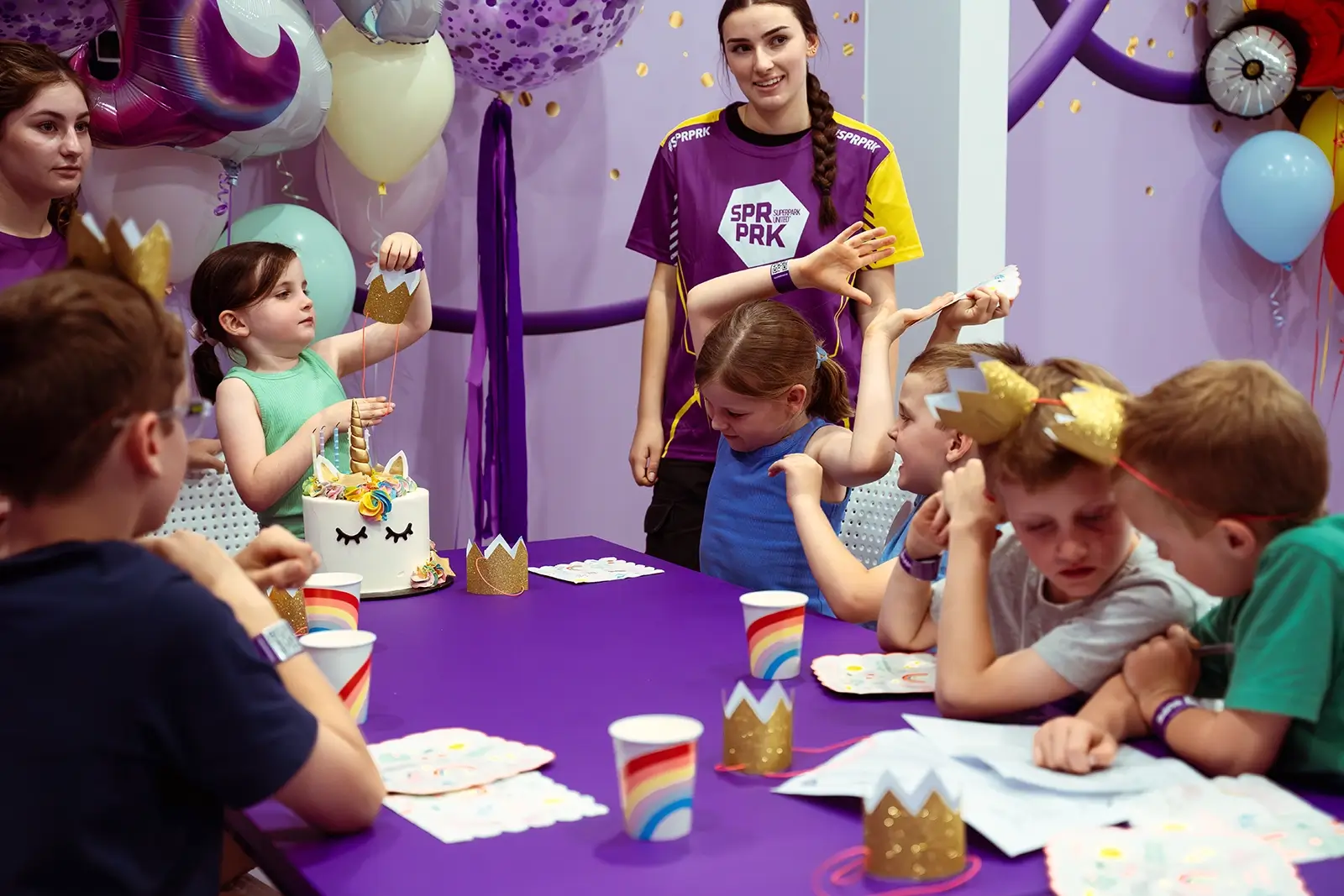 Kids sit around a birthday party table at SuperPark