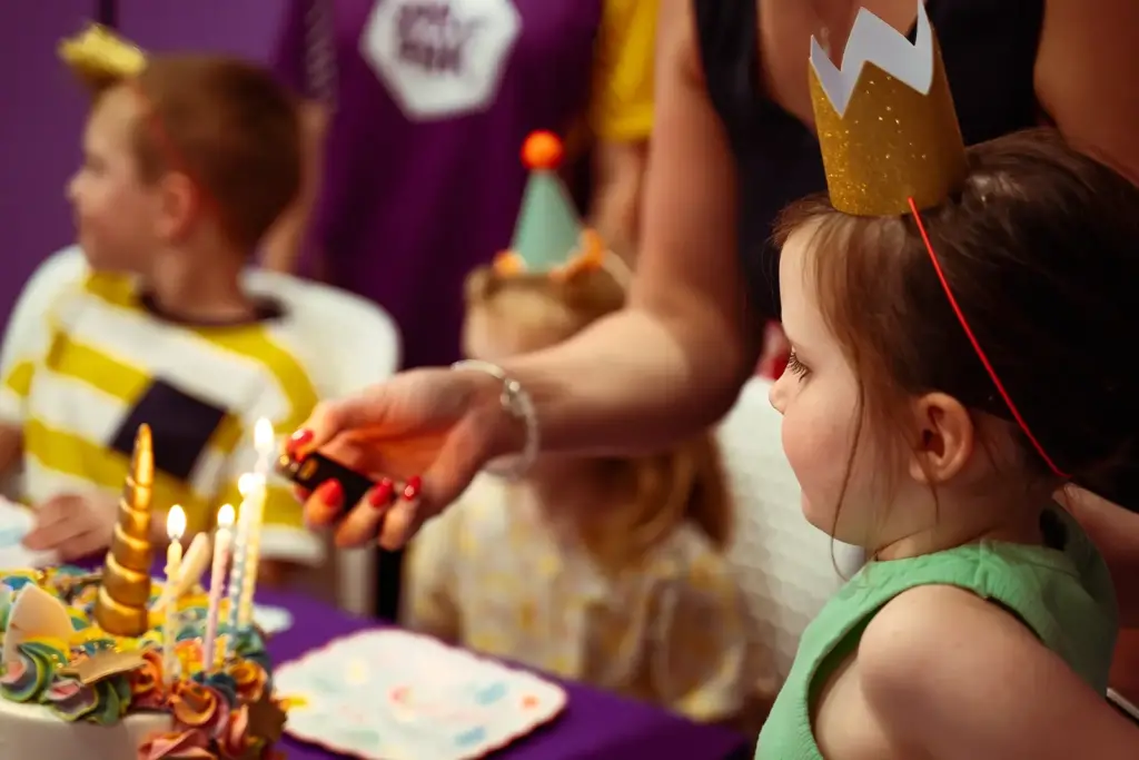 Young girl looks at her birthday cake in Melbourne