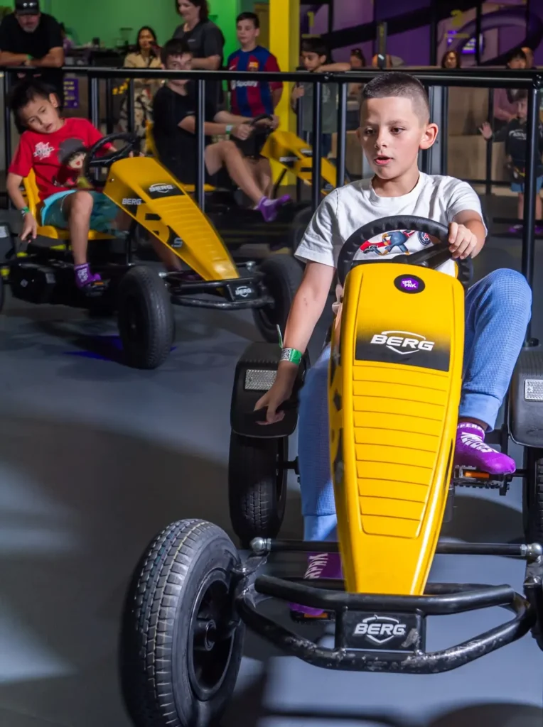 Young boy plays on the Pedal Car Track in an indoor playground-2