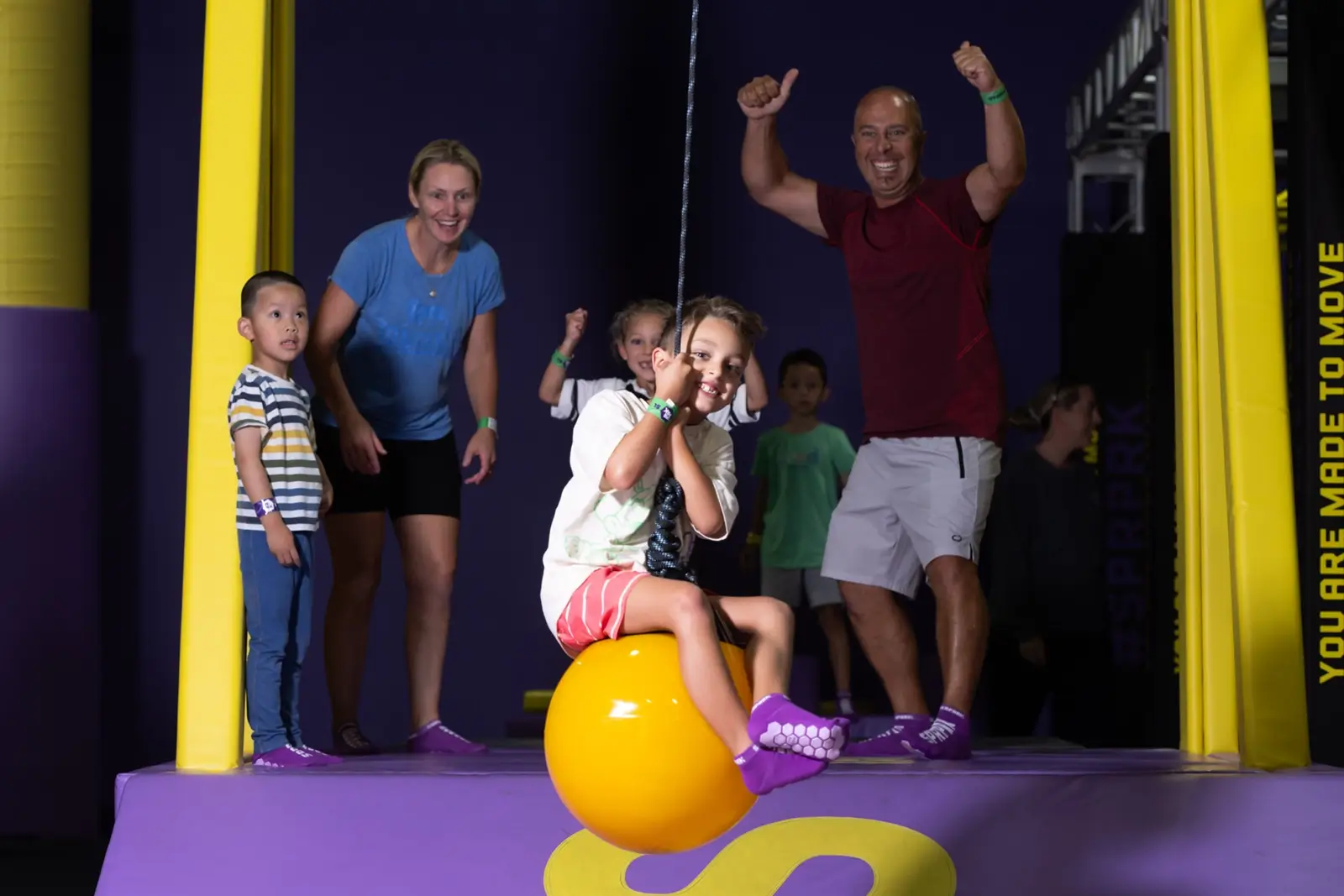 A family enjoying indoor trampoline activities