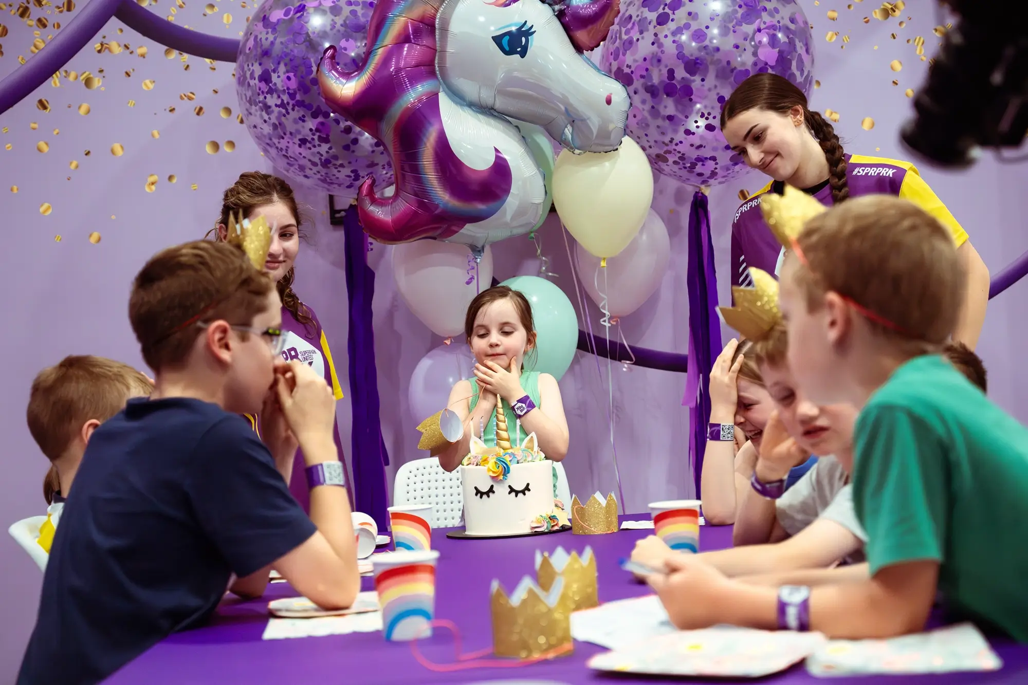 Children celebrating a birthday in an indoor playland