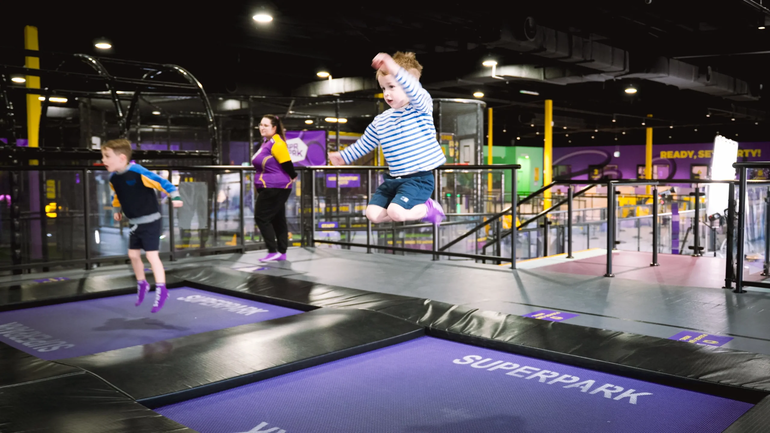 Children jumping on a trampoline in a children’s play area