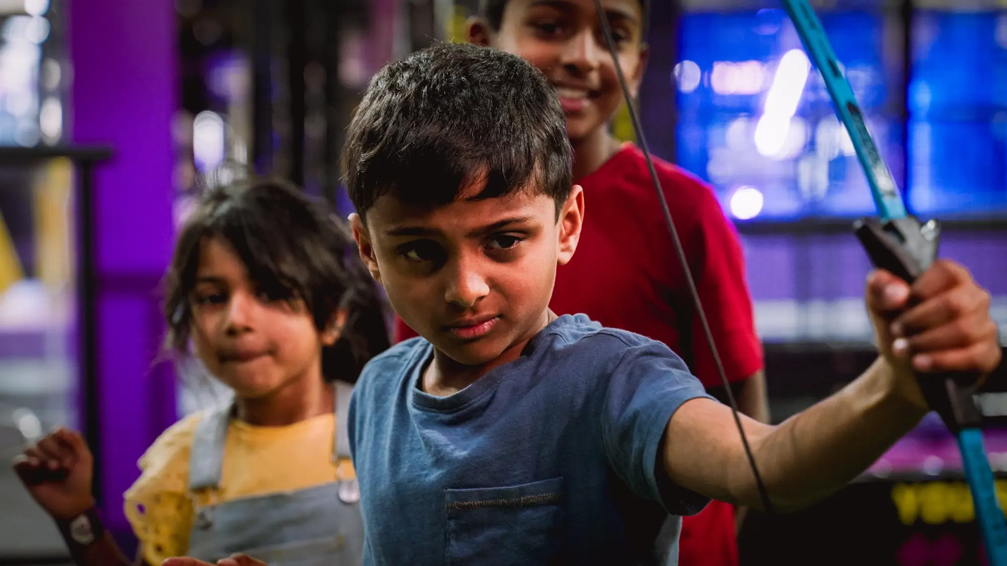 Three children engaging in kids holiday activities