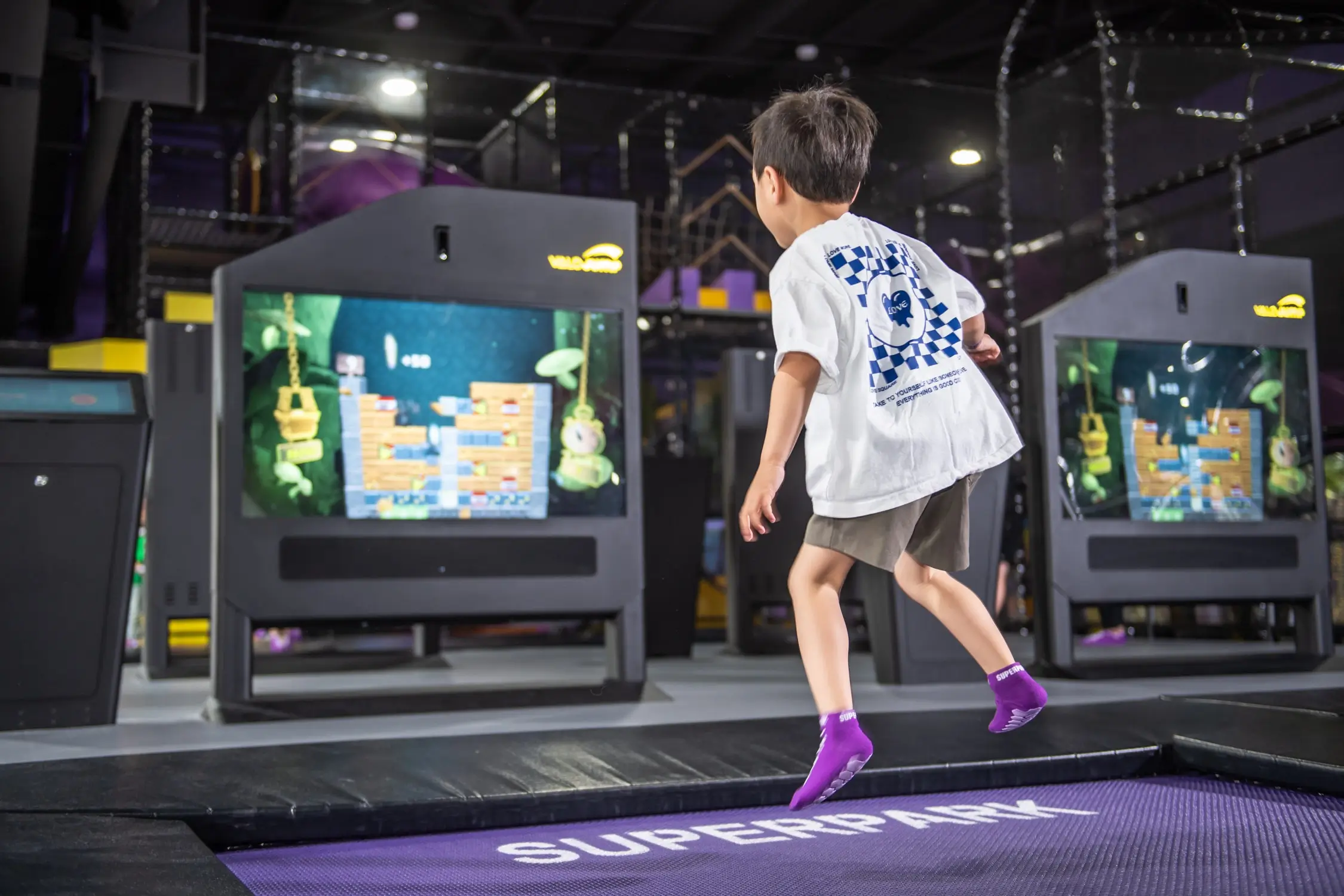 Young boy enjoys jumping on the indoor trampolines at SuperPark